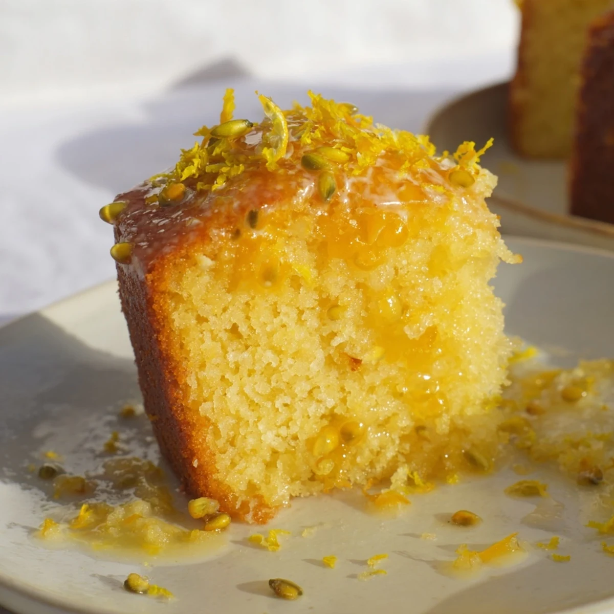 Freshly baked Glazed Lemon Poppy Seed Cake, radiating warmth, perfect with a cup of tea or coffee.