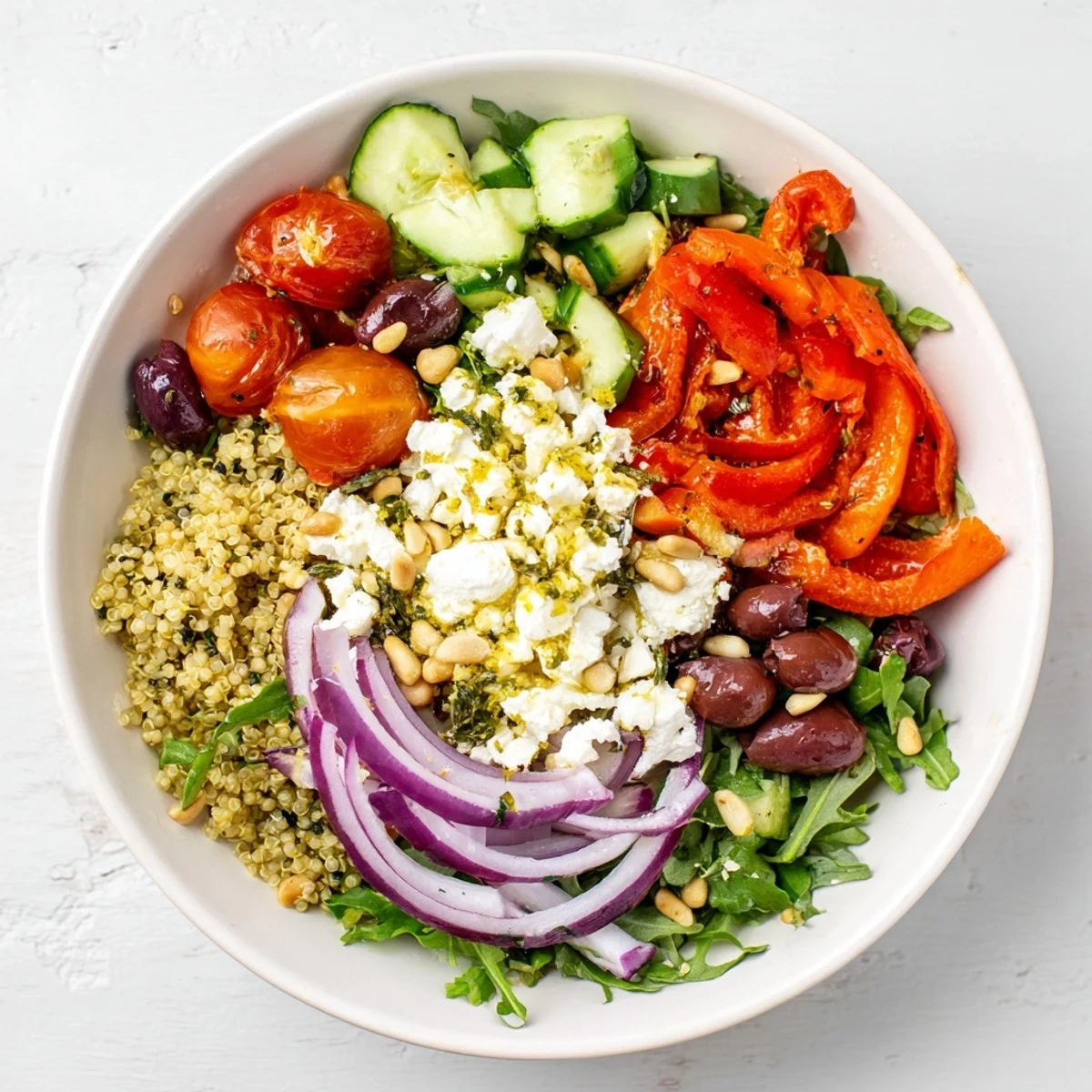 A beautifully composed Mediterranean Grain Bowl, featuring colorful vegetables and feta cheese.