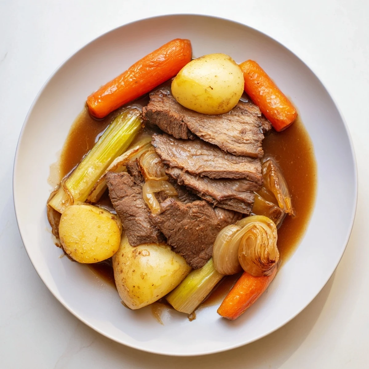 Tender Everyday Family Favorite Pot Roast, served with rich, savory root vegetables and flavorful gravy.
