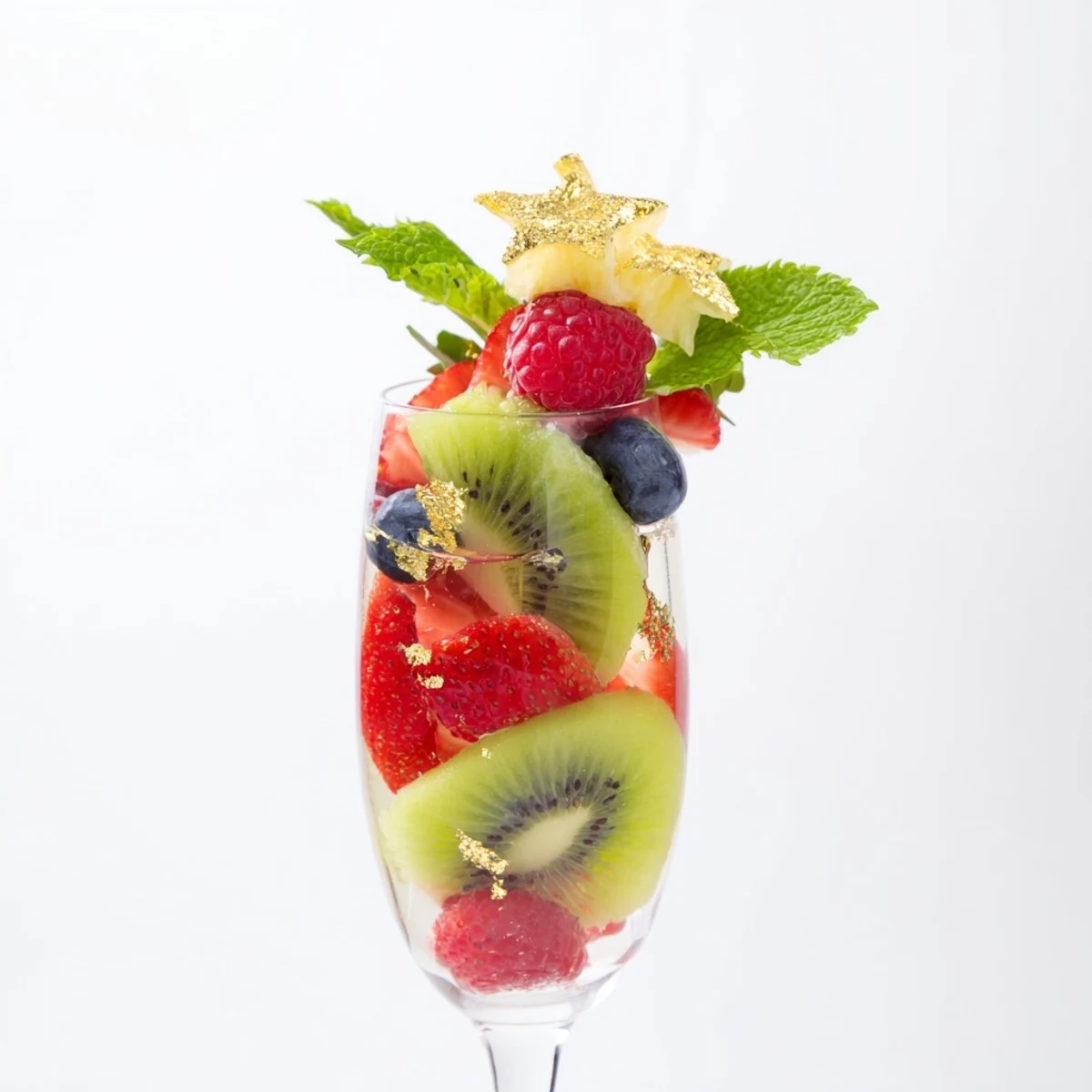 Fresh, colorful champagne flute fruit garnishes for New Years featuring vibrant strawberries and kiwi slices.