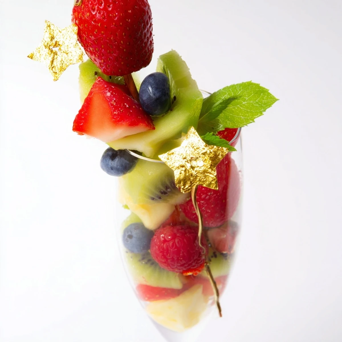 Delightful view of champagne flute fruit garnishes, ready to enhance any New Years celebration with style.