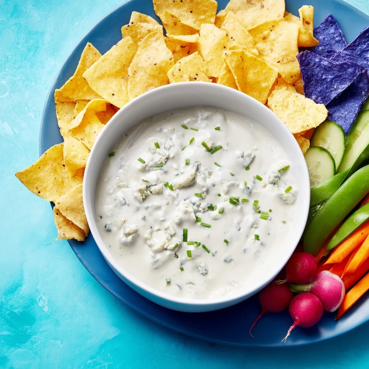 This Frozen Pond Blue Dip Platter showcases a smooth, blue dip surrounded by colorful, crunchy dippers.