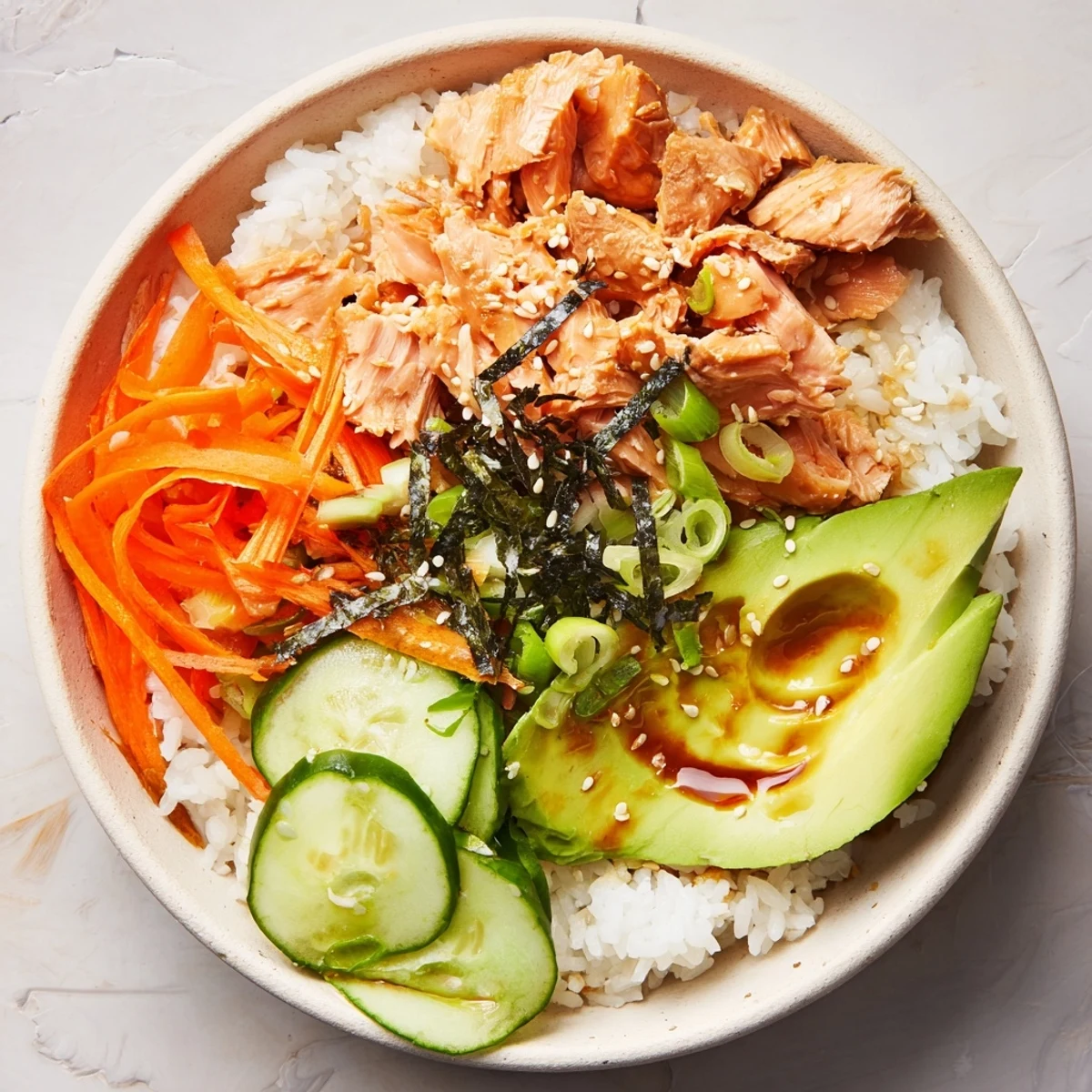 Japanese-Style Salmon & Chicken Rice Bowl with flaked salmon, sliced chicken, and vibrant, fresh vegetables.
