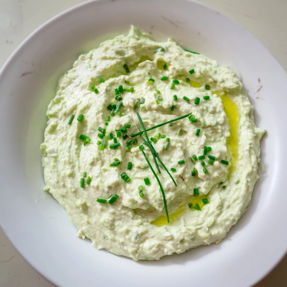 Creamy Avocado Cottage Cheese Dip, a vibrant green dip ready to serve with fresh veggies.