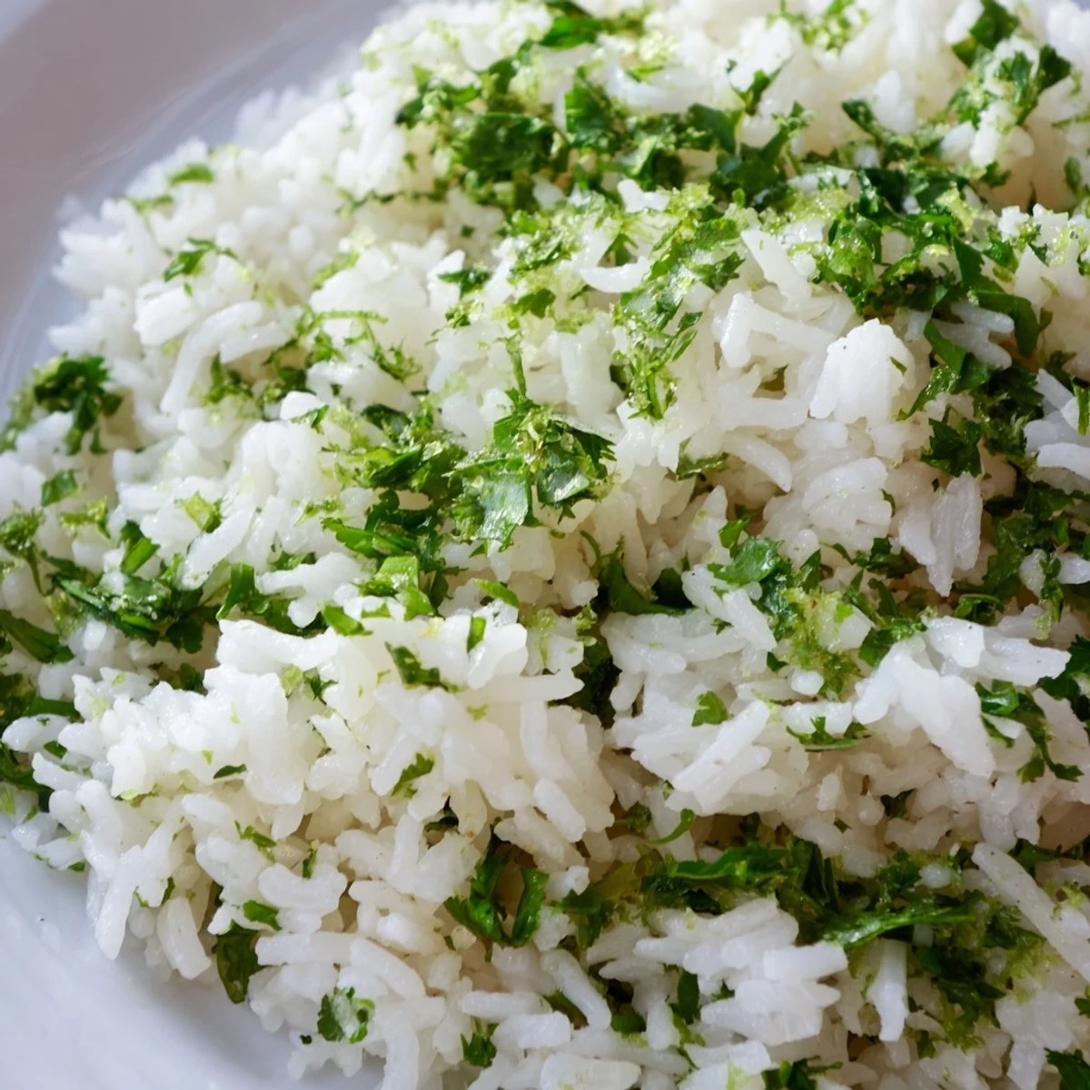 Fluffy Cilantro Lime Rice steamed to perfection, garnished with bright green cilantro leaves and lime wedges on a rustic table.