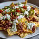 Crispy Loaded Baseball Nachos with Jalapeños and Cheese Sauce, perfect for game day snacking.