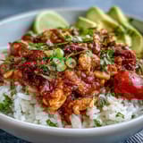 Easy slow cooker salsa chicken served over rice with colorful toppings for a quick, healthy dinner.  