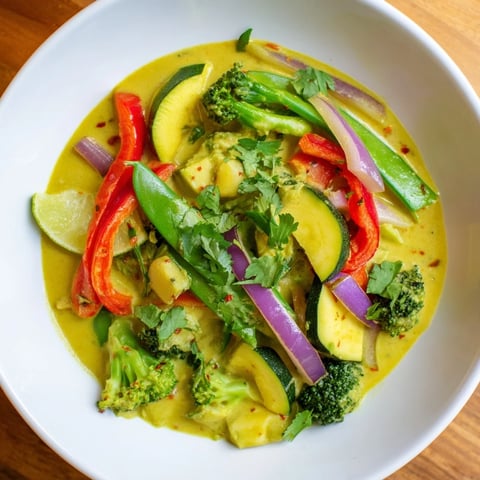 A steaming bowl of coconut curry vegetables, a flavorful vegan Indian-inspired dinner.