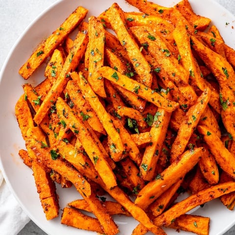 Golden, air-fried Cajun spiced sweet potato fries, a flavorful side dish ready to be enjoyed.
