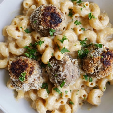 Golden bubbly Mac & Cheese Meatball Bake, a hearty casserole with cheesy, browned topping.