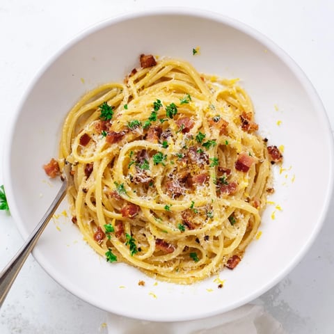 Golden, crispy bacon bits cling to al dente linguine, tossed in a glossy, garlicky sauce with fresh parsley.