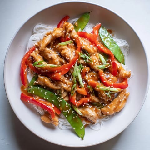 A steaming bowl of Mongolian Chicken shows juicy chicken coated in savory sauce, perfect for a weeknight dinner.