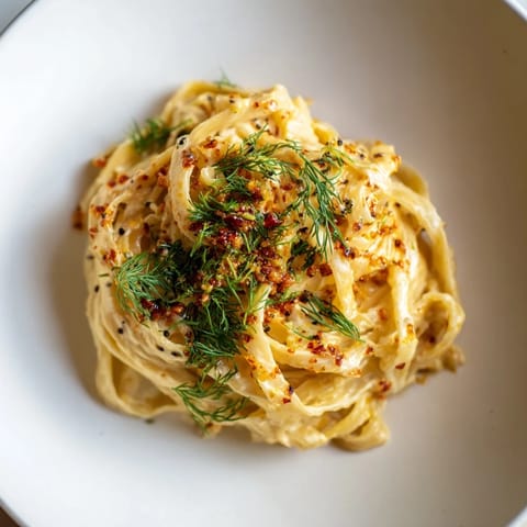 Savor the flavors: A beautiful plate of Turkish Pasta, with vibrant chili-butter drizzle.
