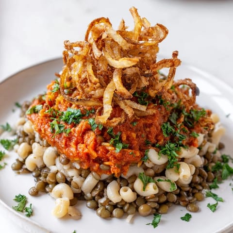 Savory and comforting, this homemade Egyptian Koshari features crispy onions, perfect for a cozy dinner.