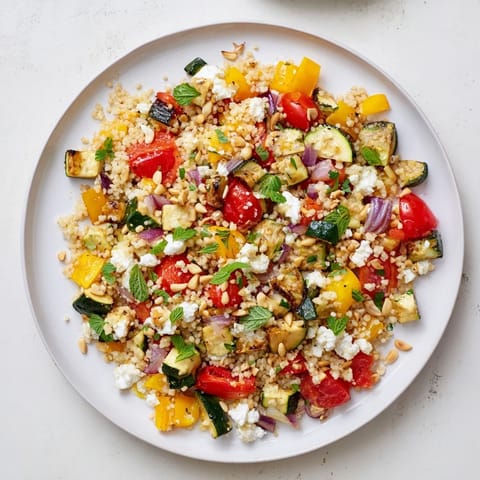 Crumbled feta and toasted pine nuts top this hearty couscous salad.