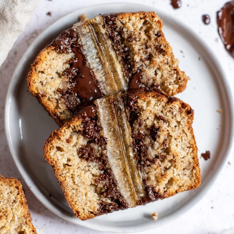 Freshly baked Chocolate Chip Banana Bread, visually appealing with abundant chocolate chip inclusions.