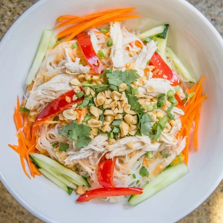 Freshly made Thai-Inspired Peanut Chicken Pasta with peanuts and cilantro, great for a summer meal idea.