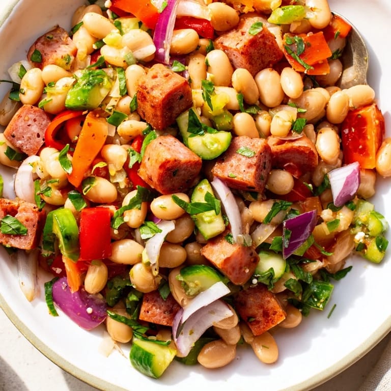 This delicious Mediterranean bean salad with salami offers a colorful medley of textures and fresh flavors, ready to eat.