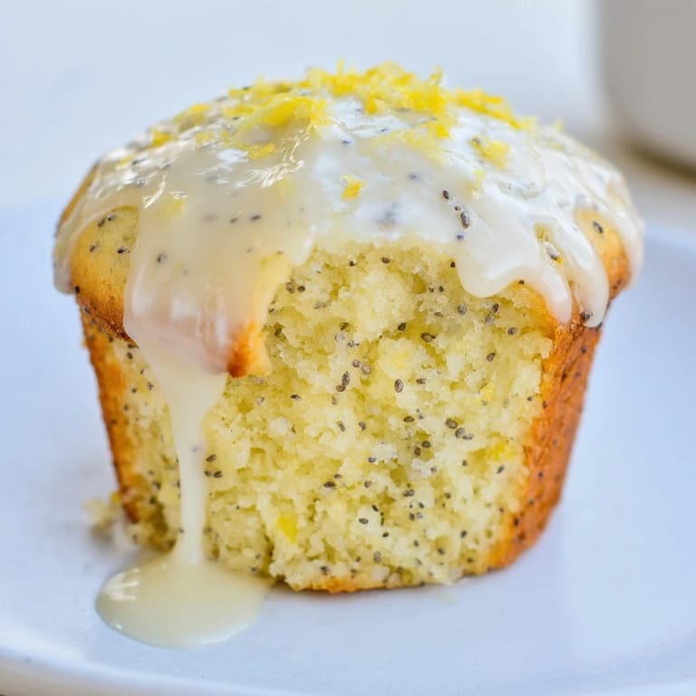 Enjoy tender Lemon Poppy Seed Muffins, perfect for brunch, alongside a cup of coffee.