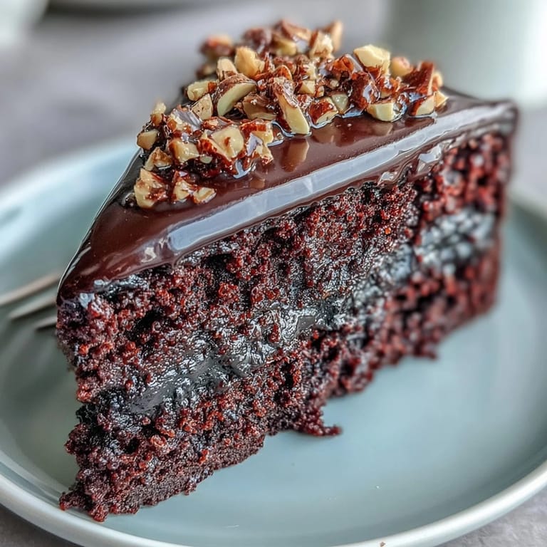 Decadent Chocolate Celebration Cake dessert with hazelnut praline garnish, perfect for birthdays or dinner parties.